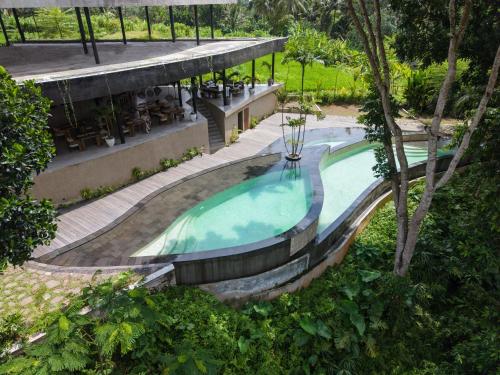 an overhead view of a swimming pool at a resort at Utopia Concept Bali - Adults Only in Ubud