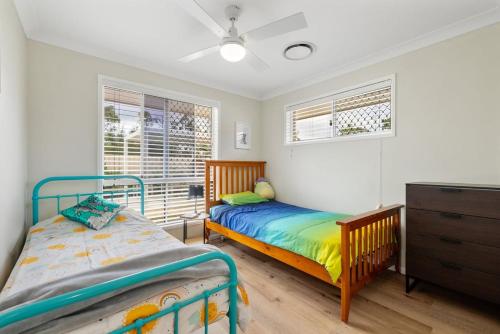 a bedroom with a twin bed and a dresser at The Salty Anchor in Banksia Beach