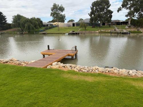 a wooden dock in the middle of a lake at 10 Jefferson Court in Wellington East