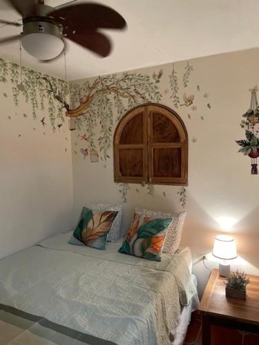 a bedroom with a bed and a ceiling fan at Casa Campana in Concepción de Ataco