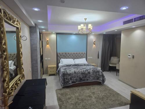 a bedroom with a large bed and a mirror at luxury hotels home in Cairo