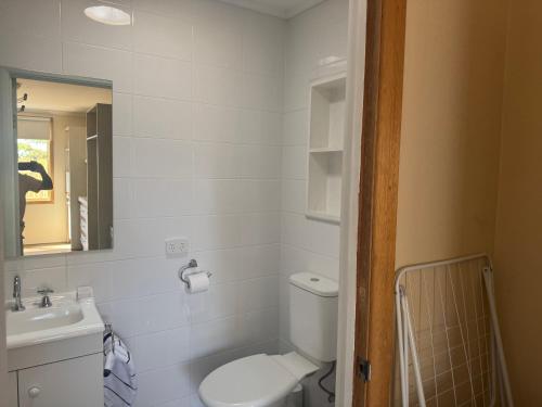 a bathroom with a toilet and a sink at Shaun place in Old Reynella