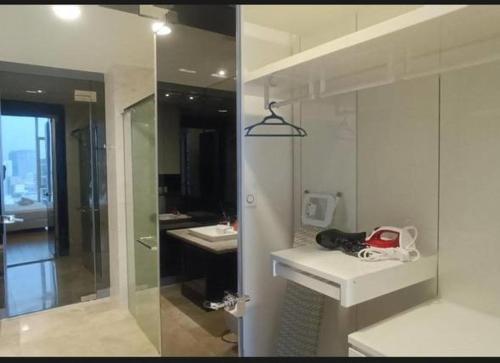a white bathroom with a sink and a shower at Platinum Face suits in Kuala Lumpur