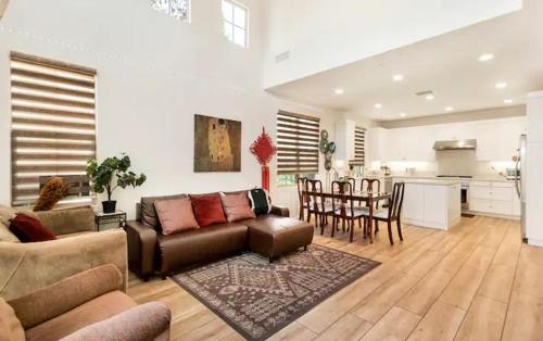 a living room with a couch and a table and a kitchen at FB Master in Irvine