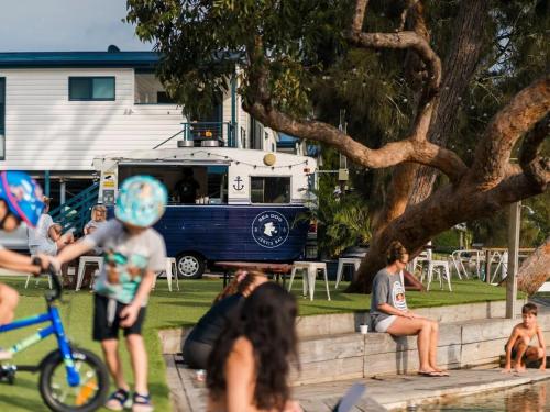 a group of people in a park with an ice cream truck at Tasman Holiday Parks - Jervis Bay in Huskisson