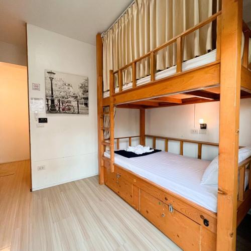 a bedroom with two bunk beds and a hallway at Bunk Boutique in Chiang Mai