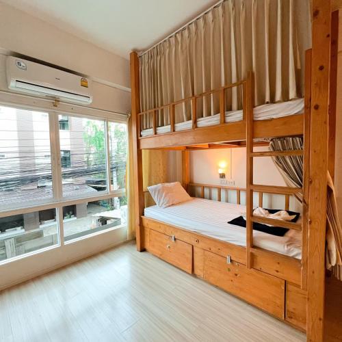 a bedroom with two bunk beds and a window at Bunk Boutique in Chiang Mai
