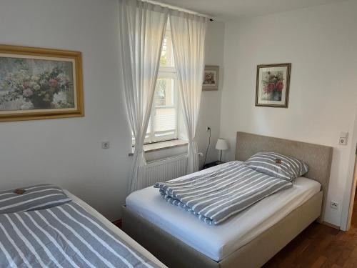 a bedroom with two beds and a window at Hugo zwei in Warburg