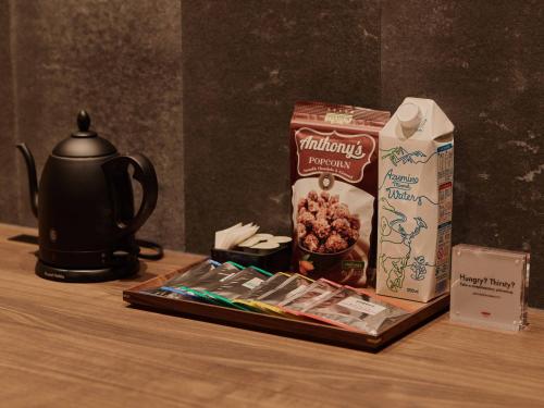 a table with a tea kettle and a box of cereal at illi Jam Shinsaibashi in Osaka