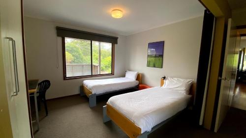 a hotel room with two beds and a window at On The Hill at Metung - Quiet Retreat with Views in Metung