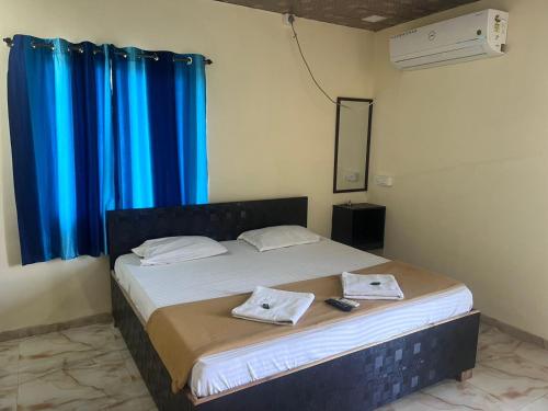 a bedroom with a bed with two towels on it at Samadhan lodge in Vangani