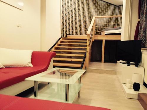 a living room with a red couch and a staircase at Old Town Boutique Apartments in Liberec