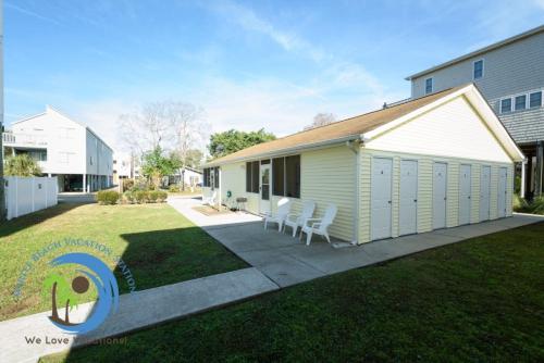 a small white building with chairs in a yard at Windy Hill Villa B - Blue Reef in Myrtle Beach
