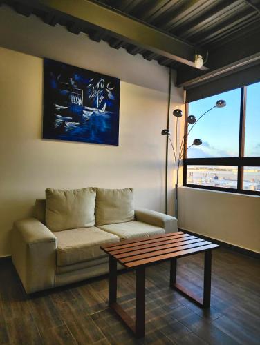 a living room with a couch and a coffee table at Torre Yaxche Urban Center in Cancún