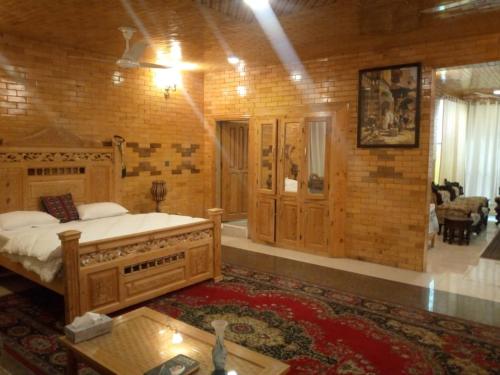 a bedroom with a large bed in a room at Gahirat Castle Chitral in Chitral