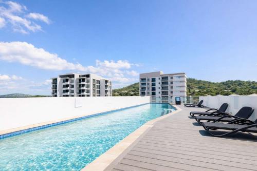 a swimming pool on the roof of a building at Home To Holiday at Holborn Apartments in Townsville in Townsville