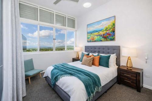 a bedroom with a bed and a window at Home To Holiday at Holborn Apartments in Townsville in Townsville