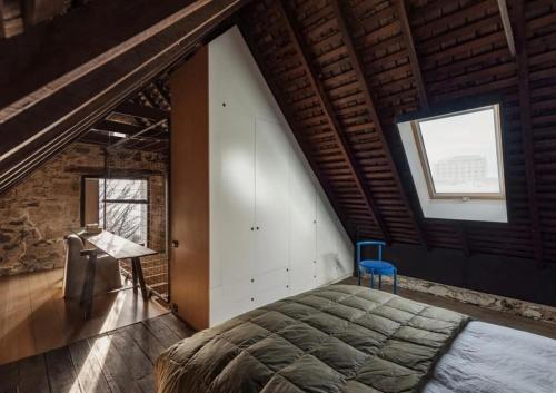 a bedroom with a large bed in a attic at The Barn Tasmania in Hobart
