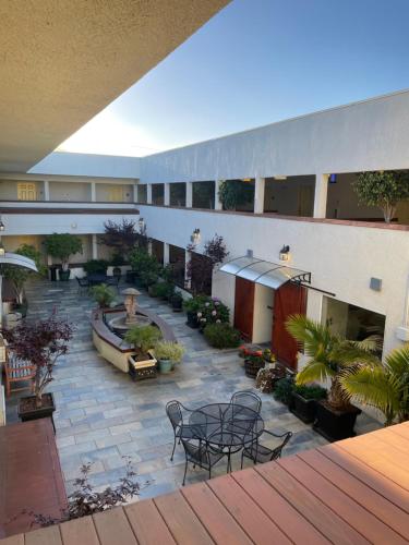 an outdoor patio with tables and chairs on a building at Airport Inn in South San Francisco