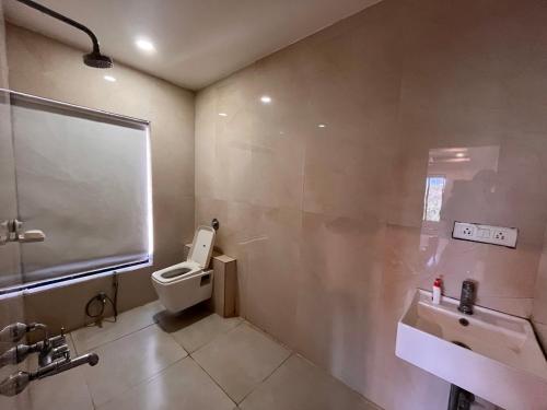 a bathroom with a toilet and a sink at Urban Nest in Nagpur