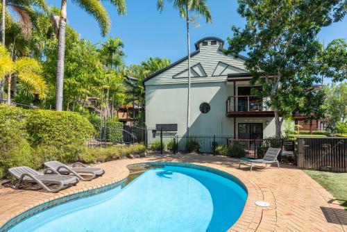 a swimming pool in front of a house at Compass Point on Hamilton Island by HIHA in Hamilton Island