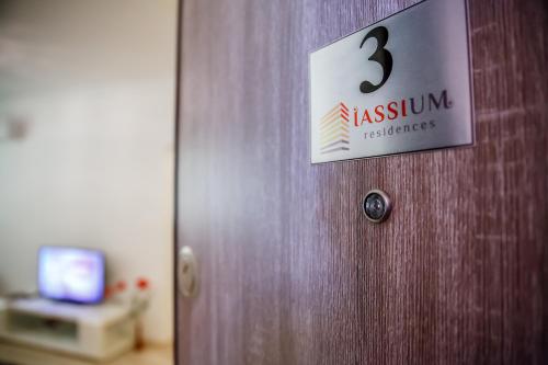 a wooden door with a sign on it at Iassium Residence Iasi in Iaşi