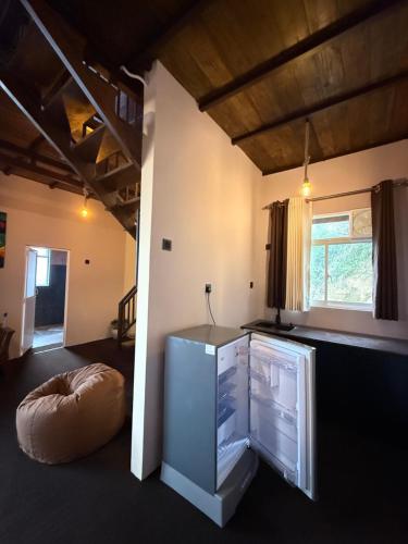 a room with a bed and a desk in it at Serene Homestay Ella in Ella