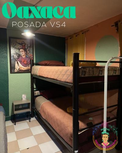 two bunk beds in a room with a sign at Posada Vs4 Aeropuerto in Mexico City