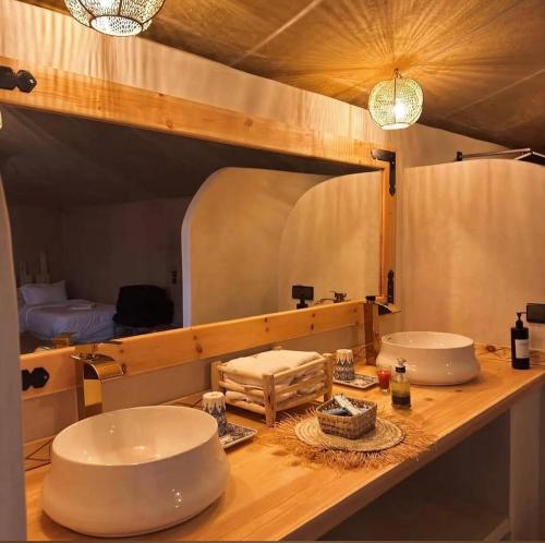 a bathroom with two sinks and a large mirror at Sahara Gift camp in Merzouga