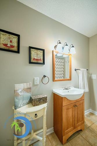 a bathroom with a sink and a mirror at Windy Hill Villa 2 - Beach Retreat in Myrtle Beach