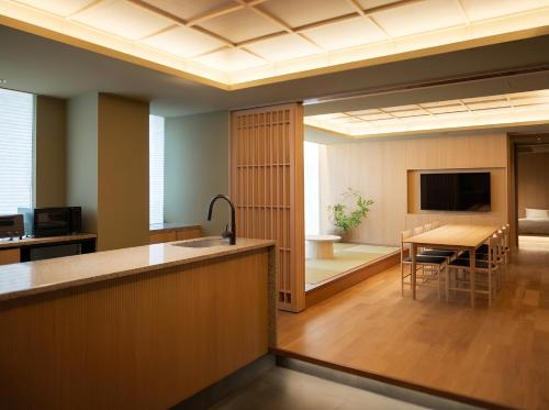 a room with a kitchen and a dining room at Apartment Hotel UCHIWA STAY Osaka NAMBA in Osaka