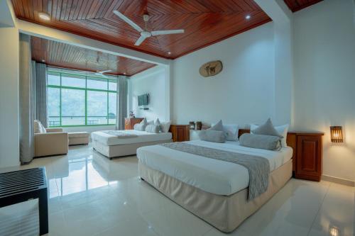a bedroom with a large bed and a fireplace at Ramboda Falls PLC in Ramboda