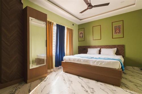 a bedroom with a bed and a mirror in it at Lotus Leaf GuestHouse in Guwahati