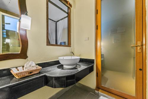 a bathroom with a sink and a mirror at Blue Bay Resort - Access to Pool and Beach-Phuket & Krabi in Ko Yao Yai