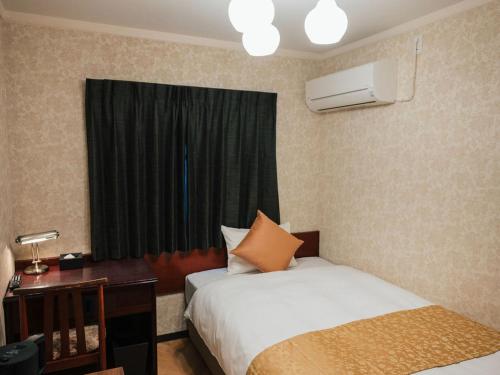 a hotel room with two beds and a window at KANSEI null 佐賀 in Saga