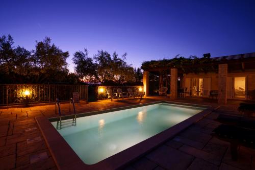 a swimming pool in a backyard at night at Ferienhaus Rovinj mit Pool in Rovinj