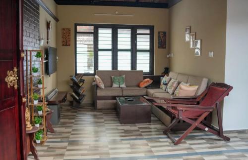 a living room with a couch and a table at Neerbhoomi in Kollam
