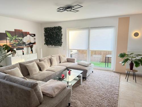 a living room with a couch and a table at Modernes Apartment in Orscholz in Mettlach