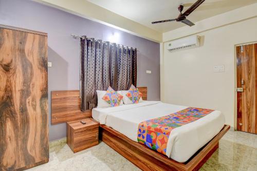 a bedroom with a bed and a ceiling fan at FabHotel Dream Sky in Kharadi