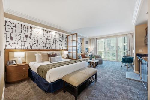 a hotel room with a large bed and a living room at Balcony Full Strip View Suite MGM Signature FREE VALET in Las Vegas