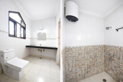a bathroom with a toilet and a sink at FabHotel Vardhmaan Inn in New Delhi