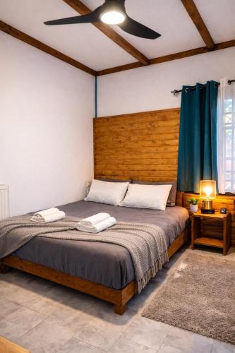 a bedroom with a bed with two towels on it at Λαμπρινής Guest House-Zagori in Asprangeloi