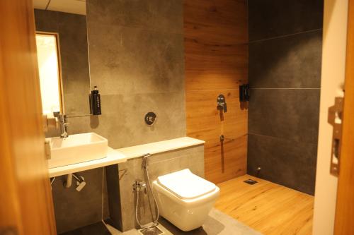 a bathroom with a toilet and a sink at Hotel Barai Palace in Dwarka
