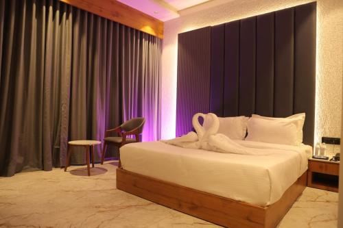 a bedroom with a bed with a towel on it at Hotel Barai Palace in Dwarka