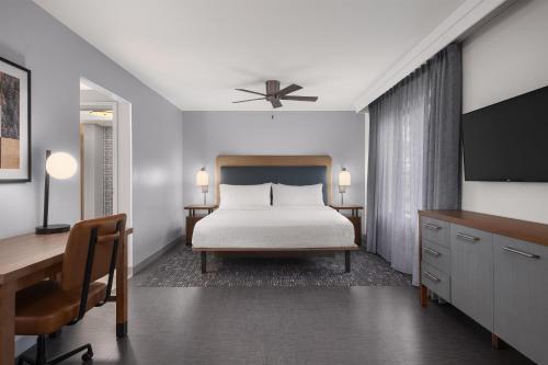 a bedroom with a bed and a desk at Homewood Suites by Hilton Fresno in Fresno