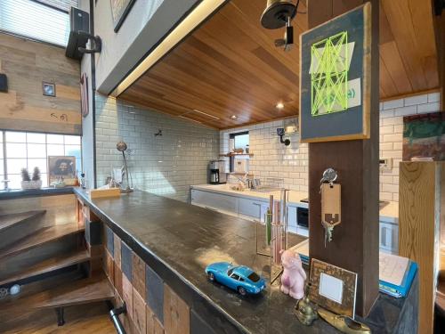 a kitchen with a counter with a toy car on it at stylish japanese beach house in Toyohashi