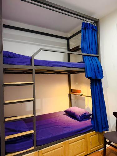 a bedroom with two bunk beds with blue sheets at Restfull apartment-14 Mai Thuc Lan, My An , Da nang in Danang