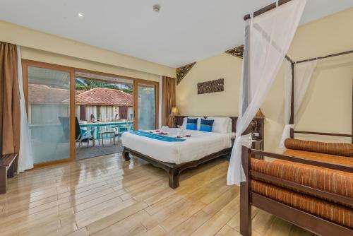 a bedroom with a bed and a balcony at Blue Bay Resort - Access to Pool and Beach-Phuket & Krabi in Ko Yao Yai
