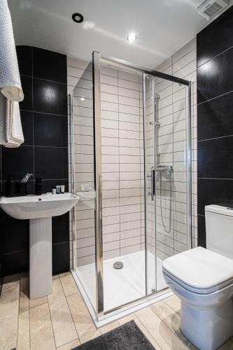 a bathroom with a shower and a toilet and a sink at Hotel LIV in Birmingham