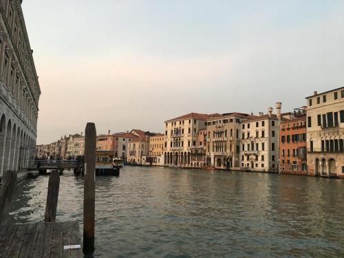 a view of a canal with buildings and a bridge at Antico Mercato in Venice